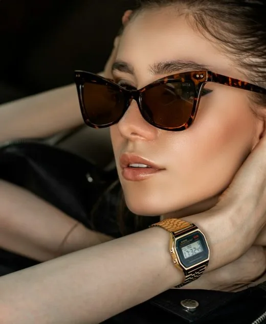 a woman wearing sunglasses sitting in a car